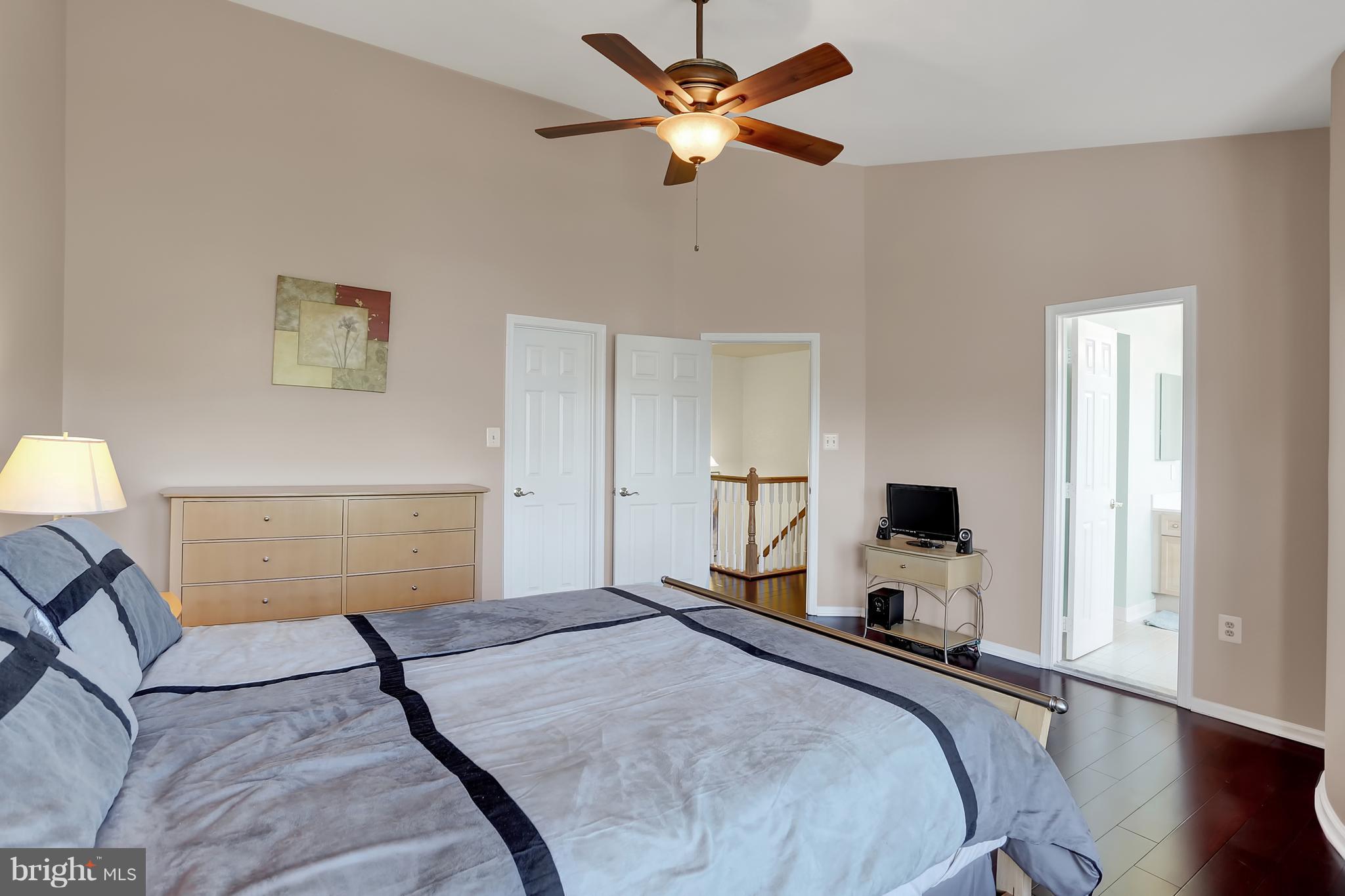 20693 Riptide Square Sterling, VA 20165 - Photo 19 of 30 a bedroom with a bed and a chandelier