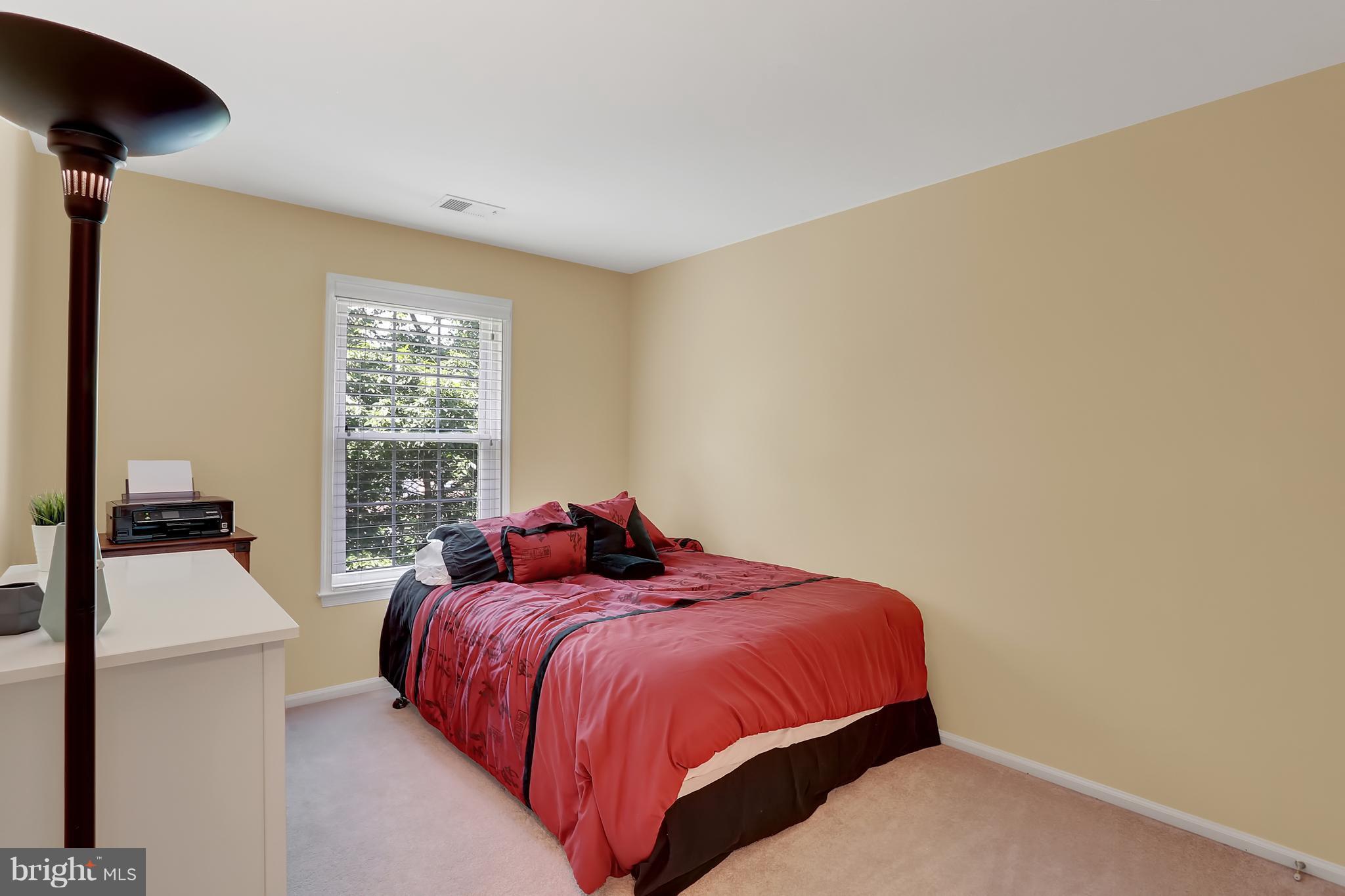 20693 Riptide Square Sterling, VA 20165 - Photo 20 of 30 a bed sitting in a bedroom next to a window