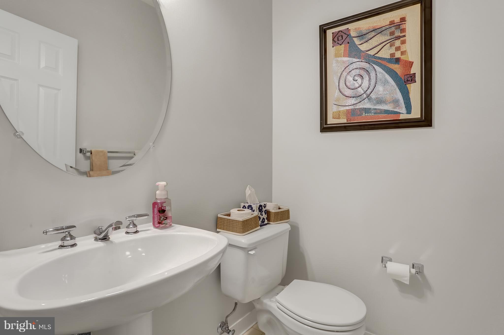 20693 Riptide Square Sterling, VA 20165 - Photo 23 of 30 a bathroom with a sink mirror and toilet