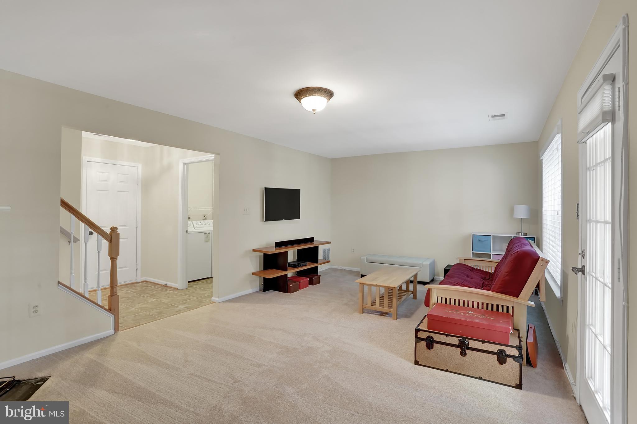 20693 Riptide Square Sterling, VA 20165 - Photo 26 of 30 a living room with furniture and a flat screen tv