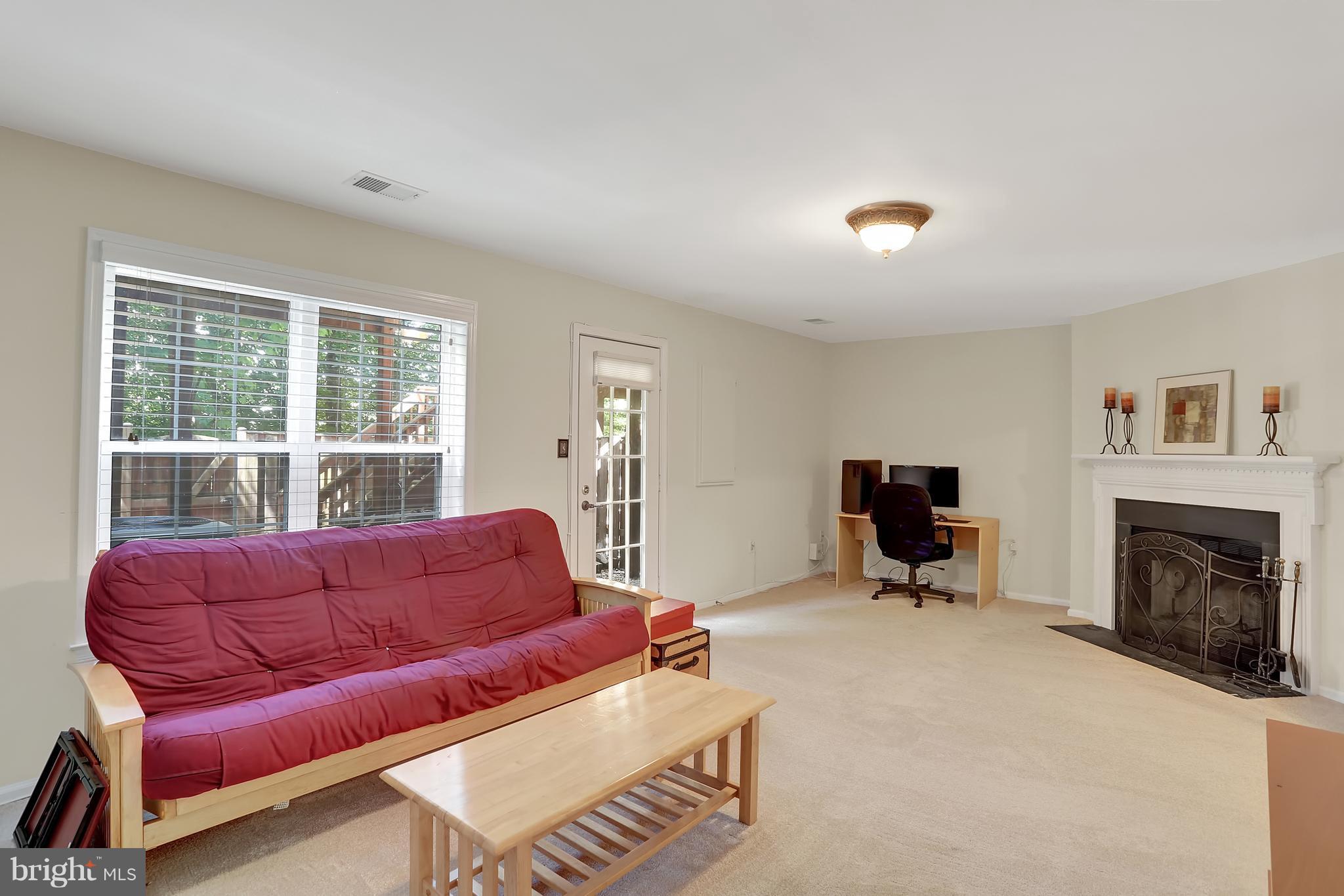 20693 Riptide Square Sterling, VA 20165 - Photo 4 of 30 a living room with furniture a fireplace and a flat screen tv