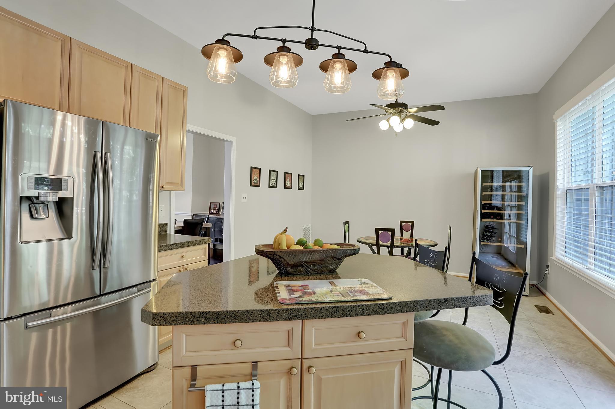 20693 Riptide Square Sterling, VA 20165 - Photo 10 of 30 a kitchen with stainless steel appliances granite countertop a dining table and chairs