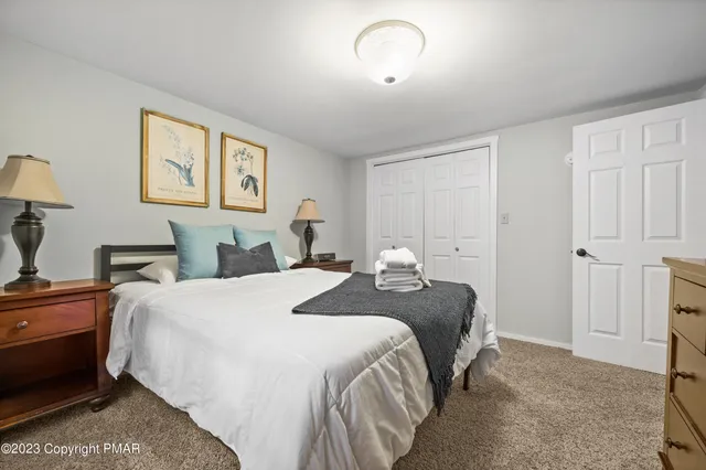 a spacious bedroom with a bed and a desk