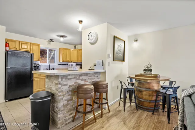a kitchen with stainless steel appliances granite countertop a kitchen island hardwood floor and a sink