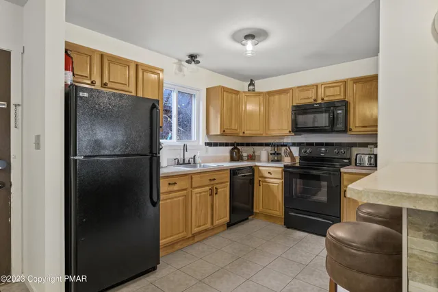 a kitchen with stainless steel appliances granite countertop a refrigerator stove and microwave