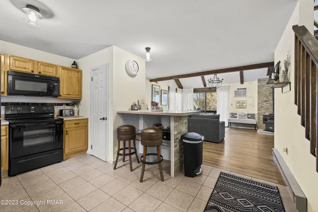 a kitchen with granite countertop a refrigerator and a stove top oven