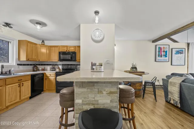 a kitchen with a table chairs sink and cabinets