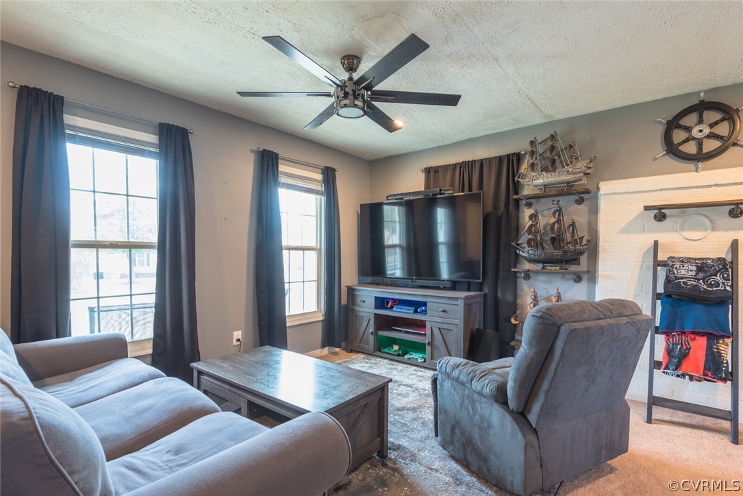4530 Twelveoaks Road Midlothian, VA 23112 - Photo 5 of 29 a living room with furniture a flat screen tv and a large window
