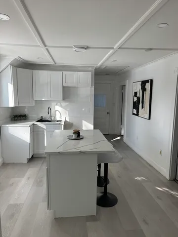 a kitchen with a sink a stove and cabinets