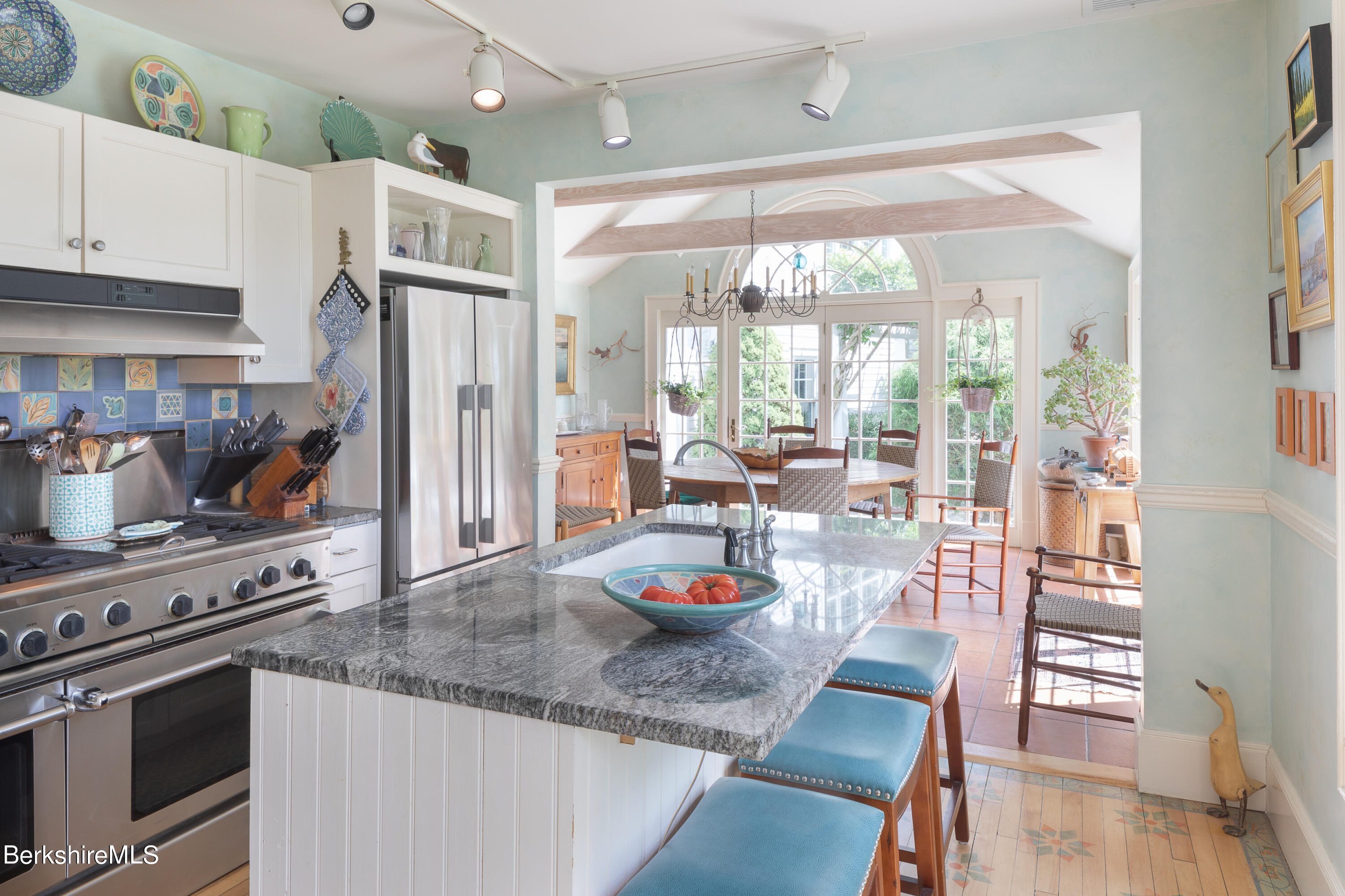 73 Scoville Road Cornwall, CT 06796 - Photo 9 of 26 a kitchen with granite countertop a table chairs stove and wooden floor