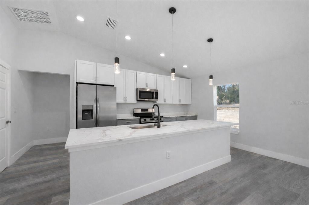 13750 Southwest 113th Lane Dunnellon, FL 34432 - Photo 11 of 26 a view of kitchen with refrigerator stove and microwave