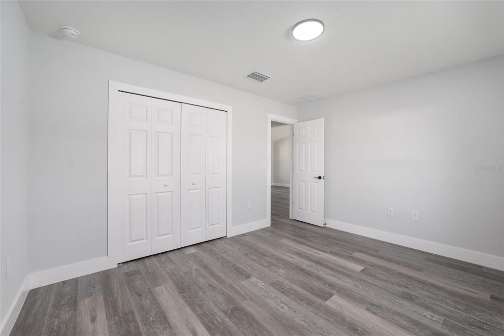 13750 Southwest 113th Lane Dunnellon, FL 34432 - Photo 19 of 26 a view of an empty room with wooden floor