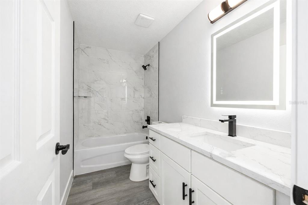 13750 Southwest 113th Lane Dunnellon, FL 34432 - Photo 22 of 26 a bathroom with a sink a toilet and a bathtub