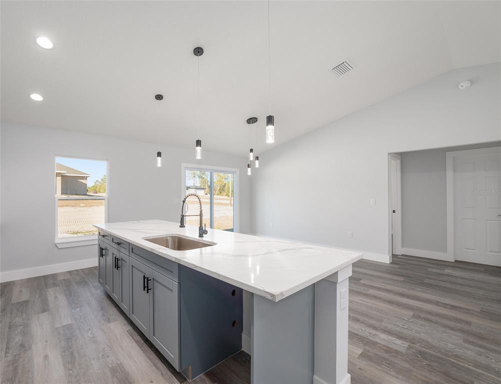 13750 Southwest 113th Lane Dunnellon, FL 34432 - Photo 7 of 26 a kitchen with a sink and wooden floor