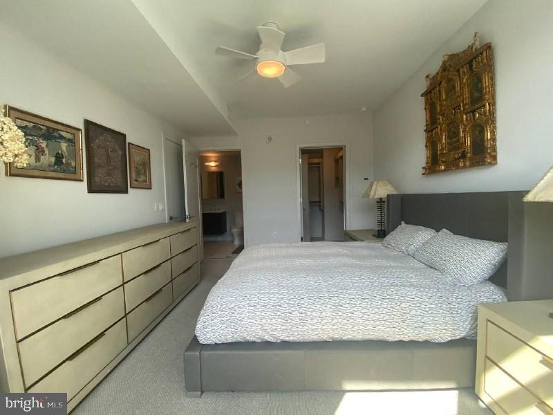 45 Sutton Square Southwest, Unit 1111 Washington, DC 20024 - Photo 15 of 20 a bedroom with a bed and a chandelier