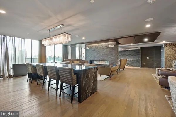 a room with lots of wooden furniture and glass windows