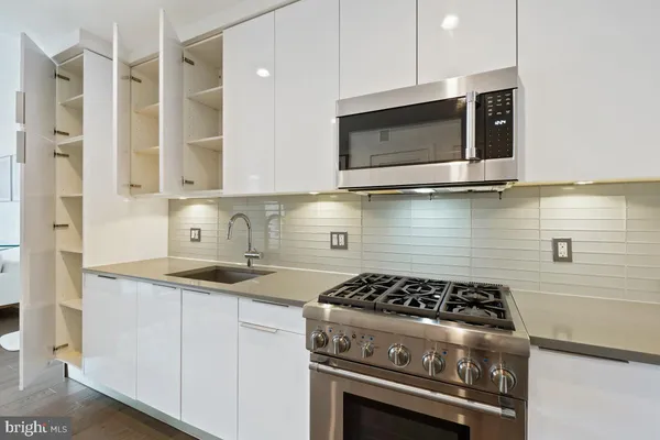 a kitchen with a stove and a microwave