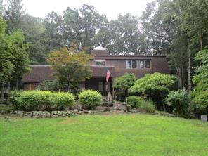 a view of a house with a yard and a garden