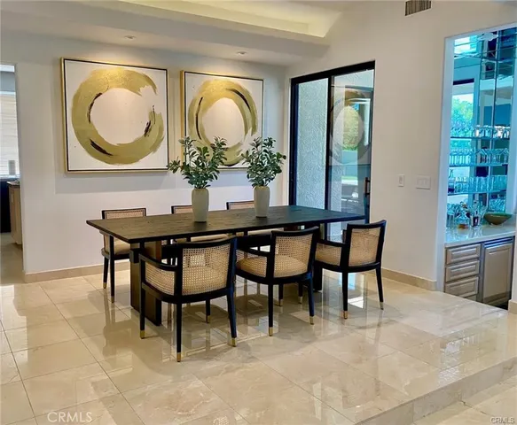 a kitchen with stainless steel appliances granite countertop a stove a sink and a granite counter tops with white cabinets