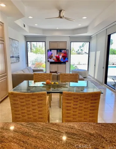 a living room with furniture and a large mirror