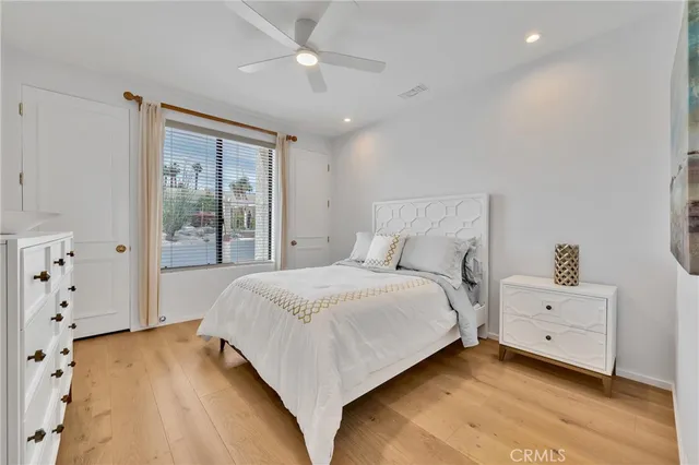 a bedroom with a bed chair and window