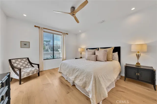 a large en suite bathroom with a tub double vanity and mirrors