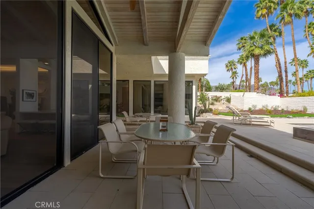 a view of swimming pool with outdoor seating and plants