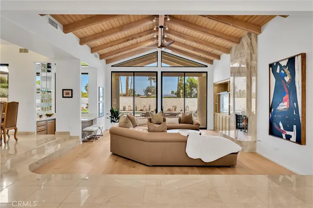 a living room with fireplace furniture and a chandelier