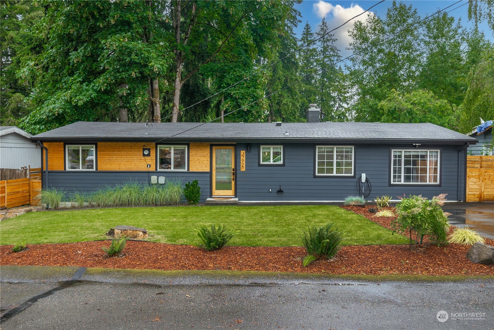 17920 91st Place Northeast Bothell, WA 98011 - Photo 1 of 39 a front view of a house with a garden and trees
