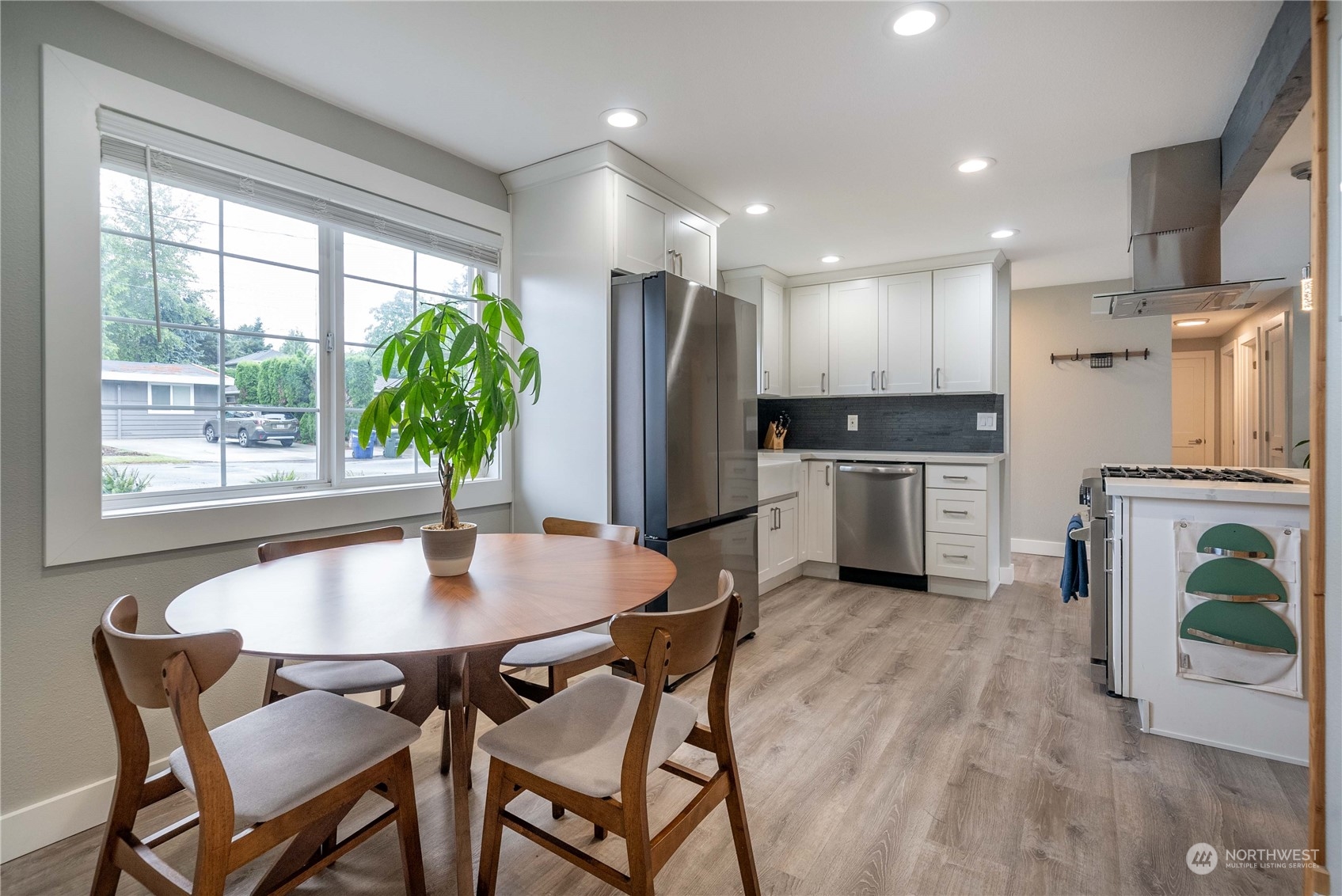 17920 91st Place Northeast Bothell, WA 98011 - Photo 19 of 39 a kitchen with a table chairs refrigerator and microwave
