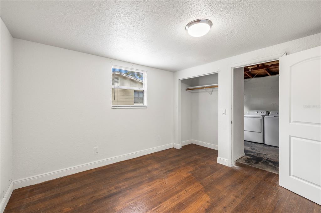 10803 Hyssop Street Port Richey, FL 34668 - Photo 19 of 42 an empty room with wooden floor and a window