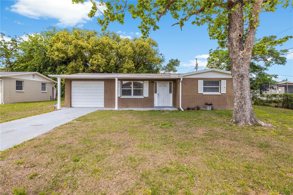 10803 Hyssop Street Port Richey, FL 34668 - Photo 2 of 42 a view of a house with a backyard