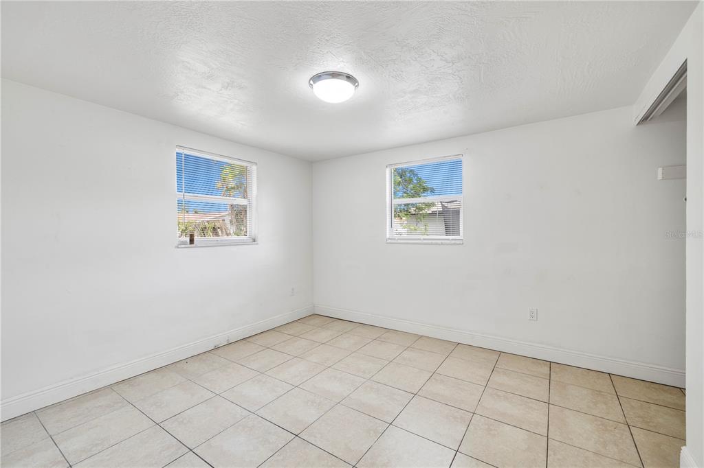 10803 Hyssop Street Port Richey, FL 34668 - Photo 22 of 42 an empty room with windows