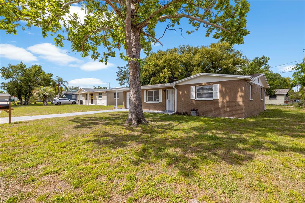 10803 Hyssop Street Port Richey, FL 34668 - Photo 30 of 42 a view of a house with a yard