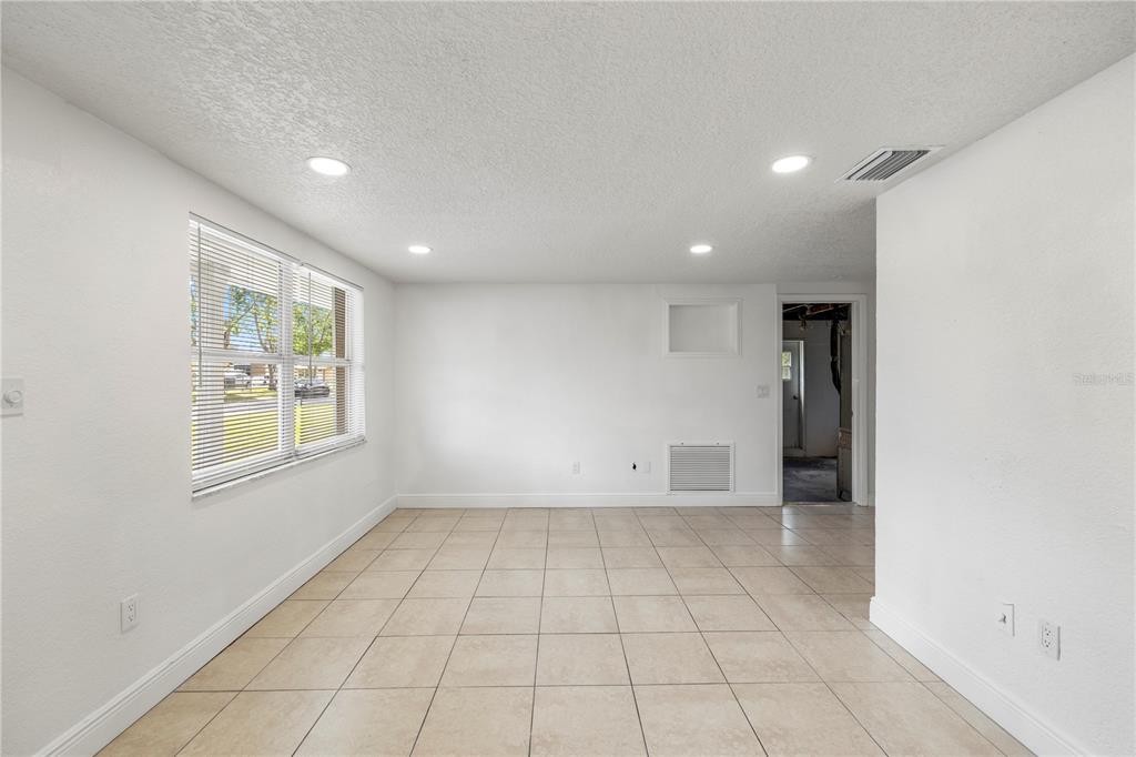10803 Hyssop Street Port Richey, FL 34668 - Photo 6 of 42 a view of an empty room with a window