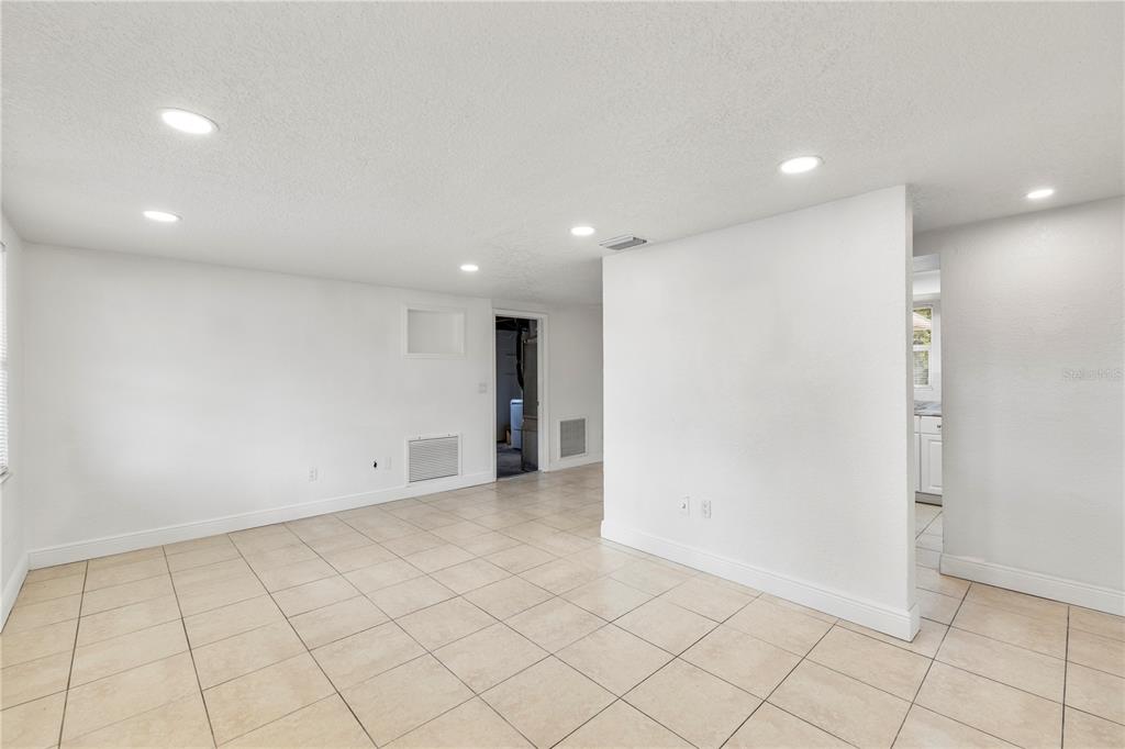 10803 Hyssop Street Port Richey, FL 34668 - Photo 8 of 42 an empty room with kitchen view