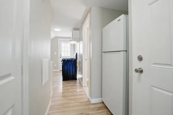 a view of a hallway with wooden floor