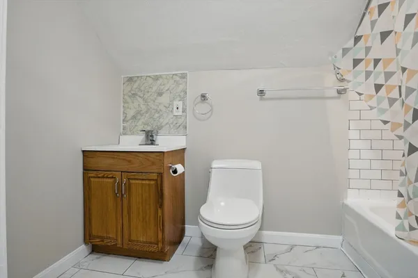 a bathroom with a toilet a sink and bathtub
