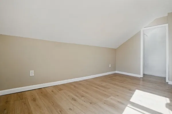 an empty room with wooden floor