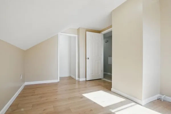 an empty room with wooden floor