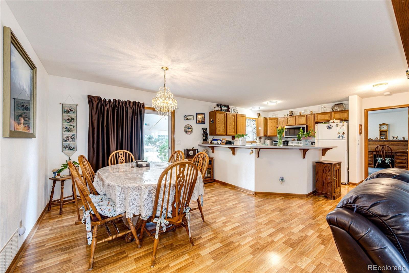 4420 Behrens Road Byers, CO 80103 - Photo 6 of 39 a view of a dining room with furniture and a kitchen
