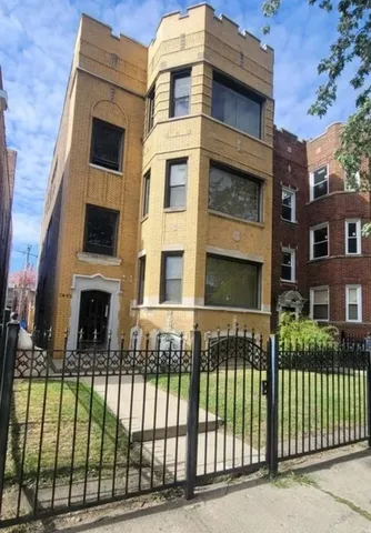 a view of a brick building with many windows