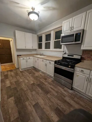 a kitchen with granite countertop a stove and a sink