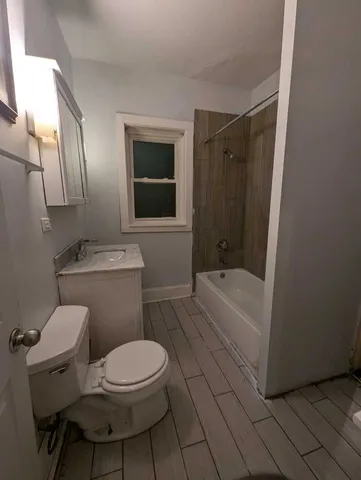 a bathroom with a toilet a sink and bathtub
