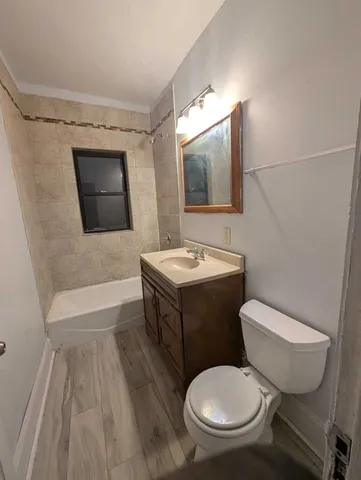 a bathroom with a toilet a sink and bathtub