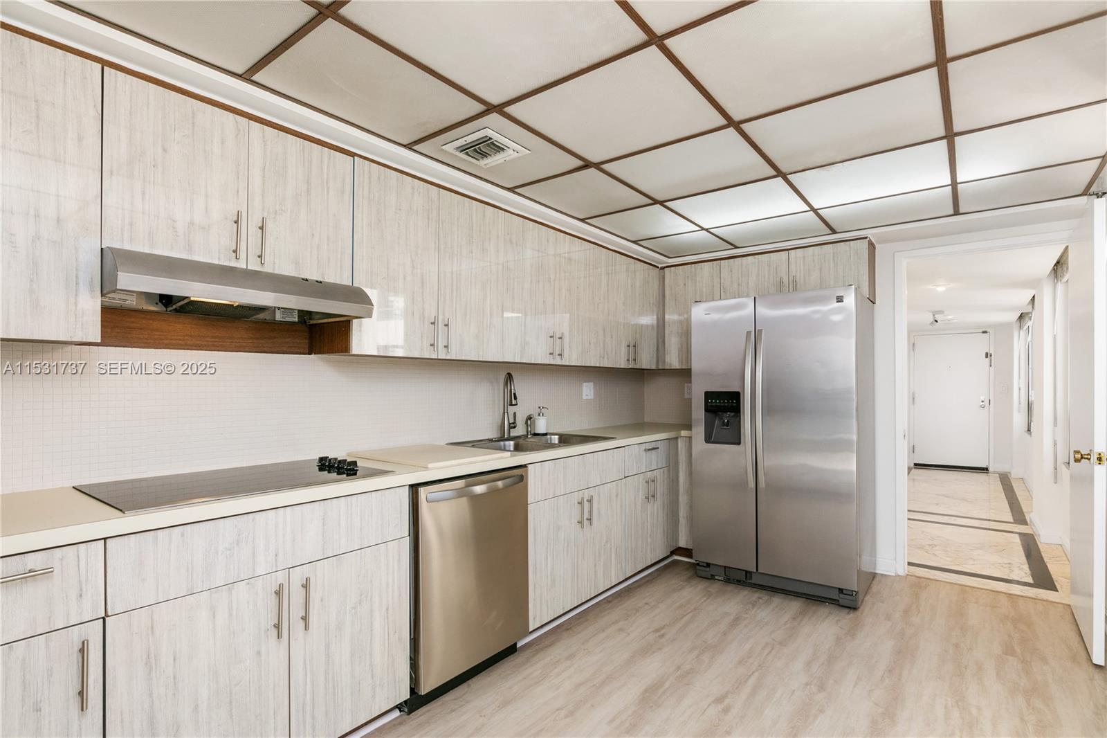 1541 Brickell Avenue, Unit C1507 Miami, FL 33129 - Photo 11 of 69 a kitchen with stainless steel appliances a sink cabinets and wooden floor