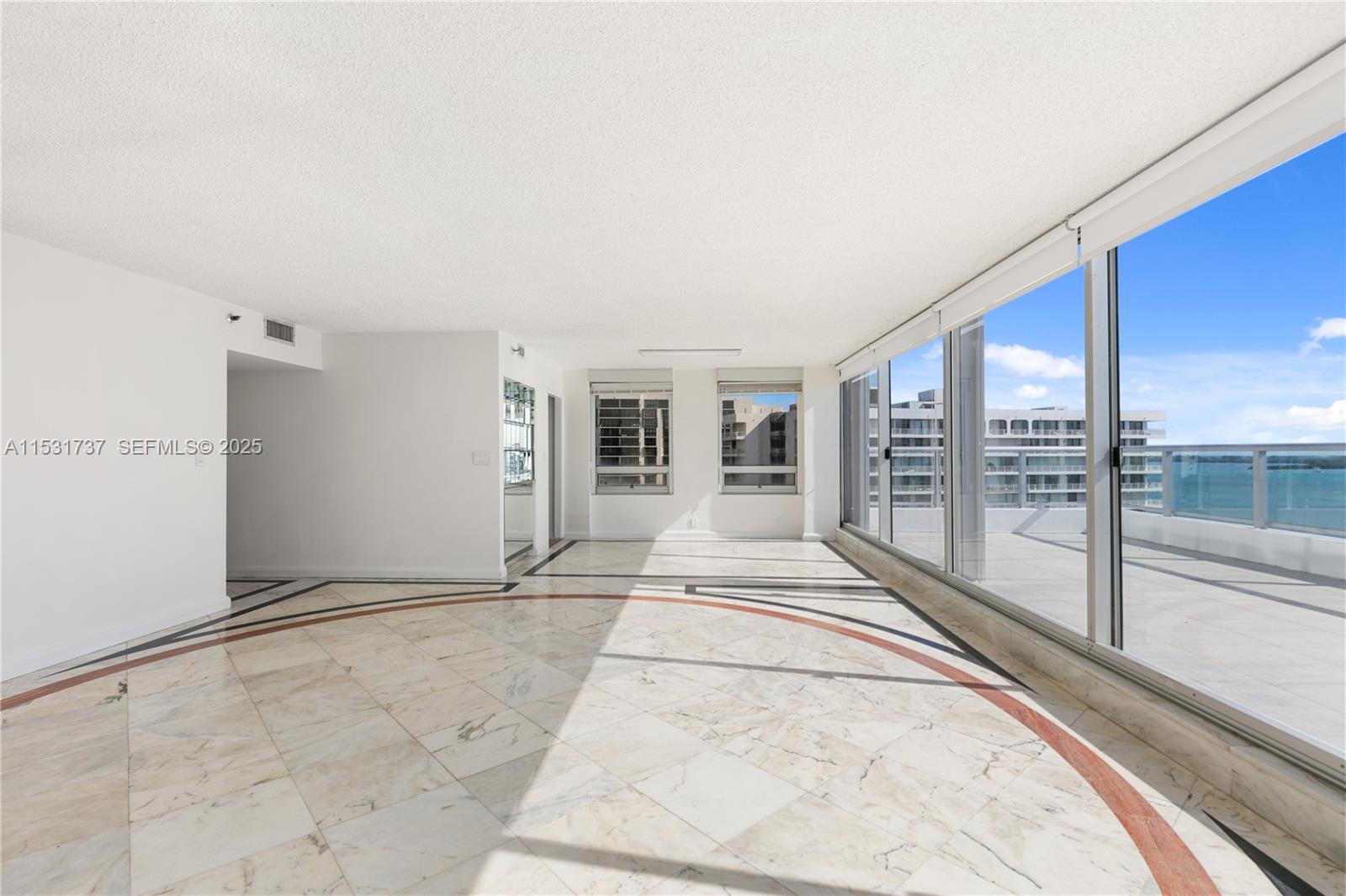 1541 Brickell Avenue, Unit C1507 Miami, FL 33129 - Photo 8 of 69 a view of an empty room with a balcony and glass door