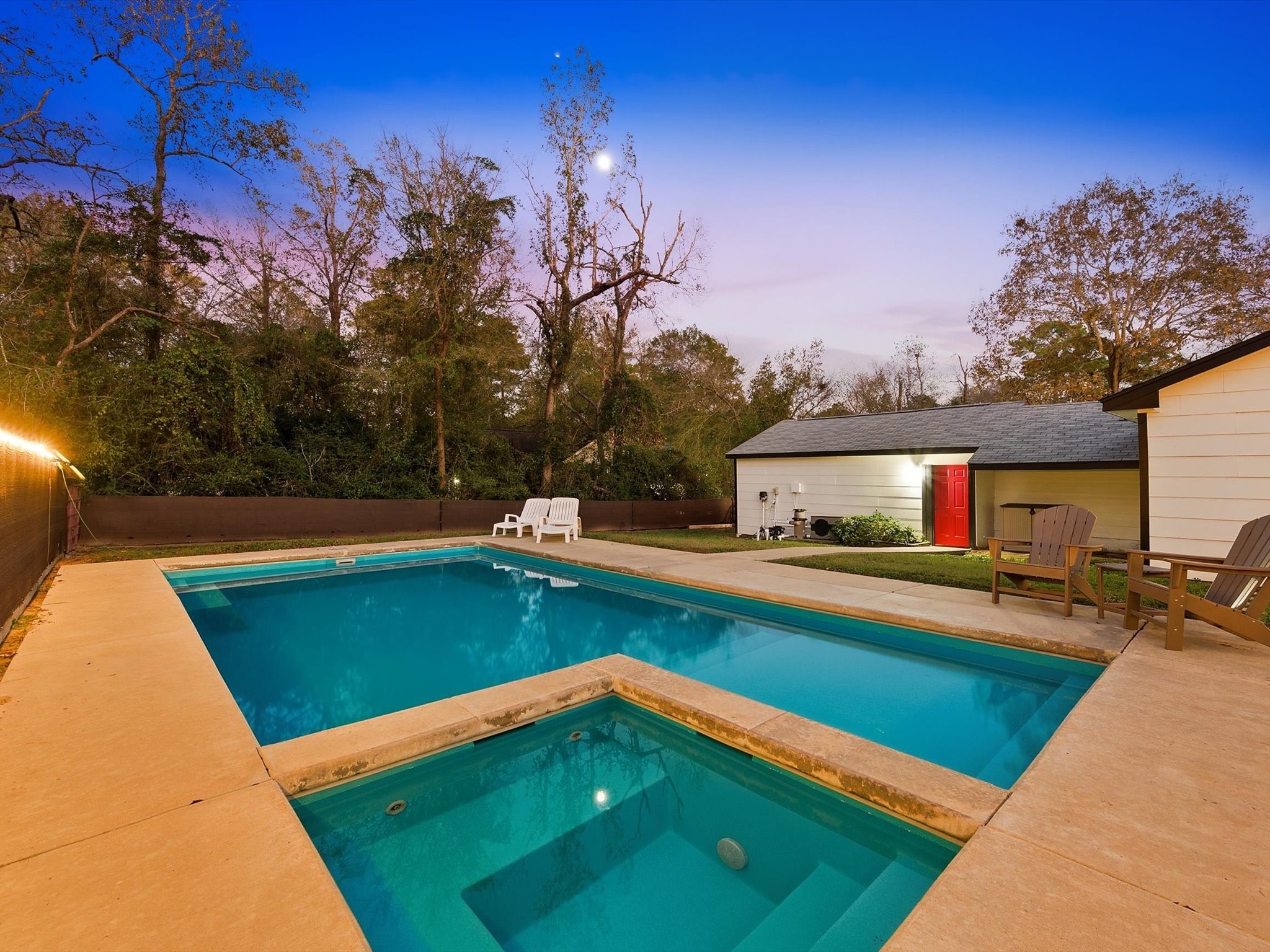 10277 Champion Forest Loop Conroe, TX 77303 - Photo 2 of 45 a view of swimming pool with seating area and trees in the background