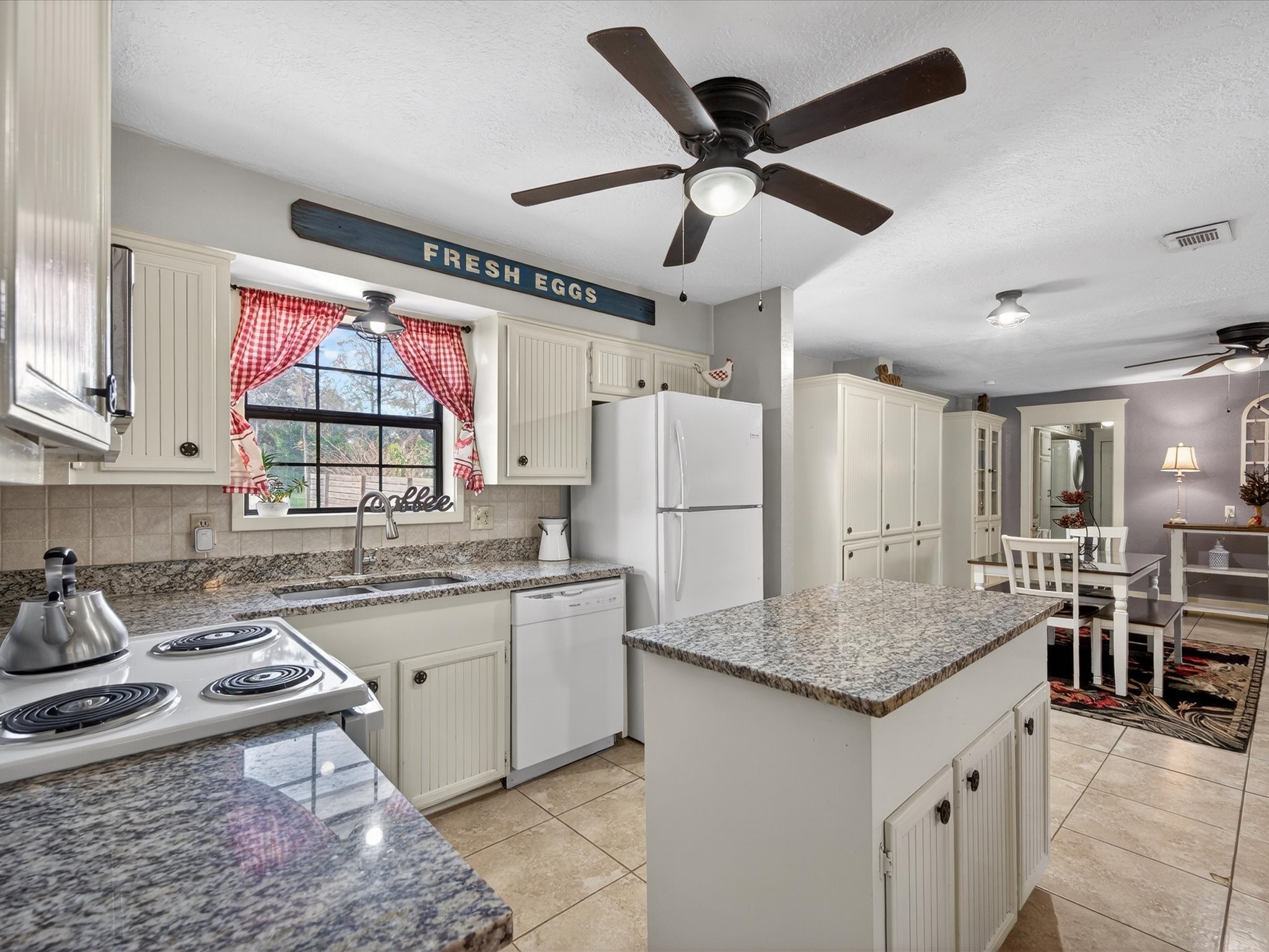 10277 Champion Forest Loop Conroe, TX 77303 - Photo 21 of 45 a kitchen with stainless steel appliances granite countertop a sink stove and refrigerator