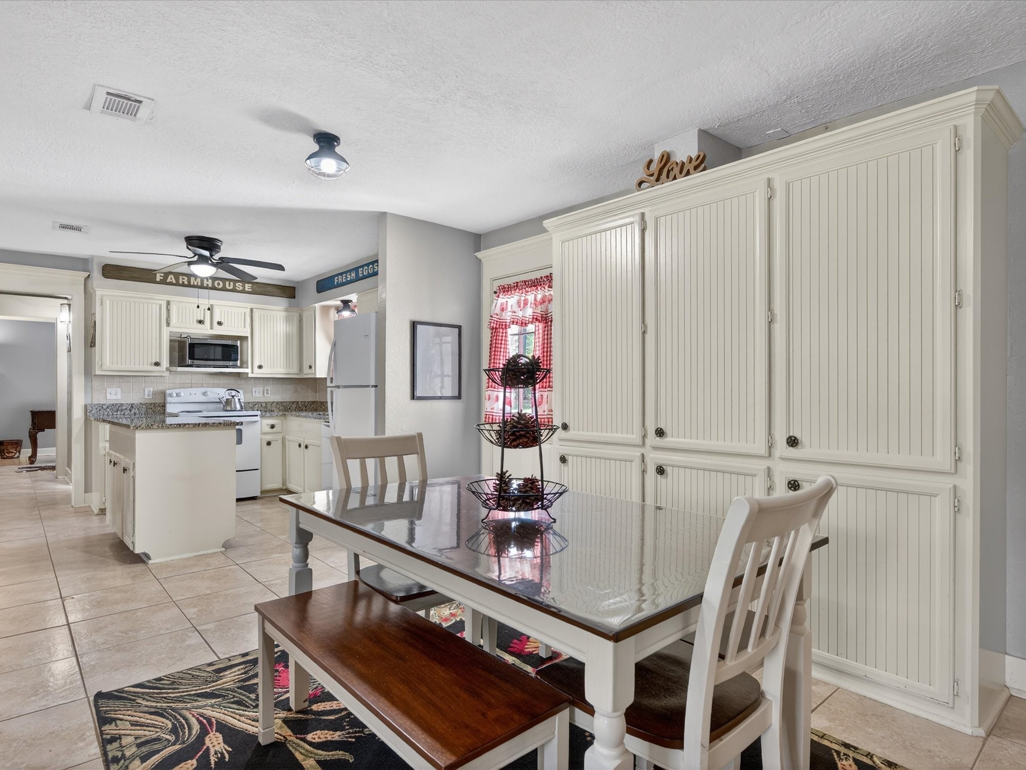 10277 Champion Forest Loop Conroe, TX 77303 - Photo 23 of 45 a kitchen with stainless steel appliances granite countertop a stove and a refrigerator